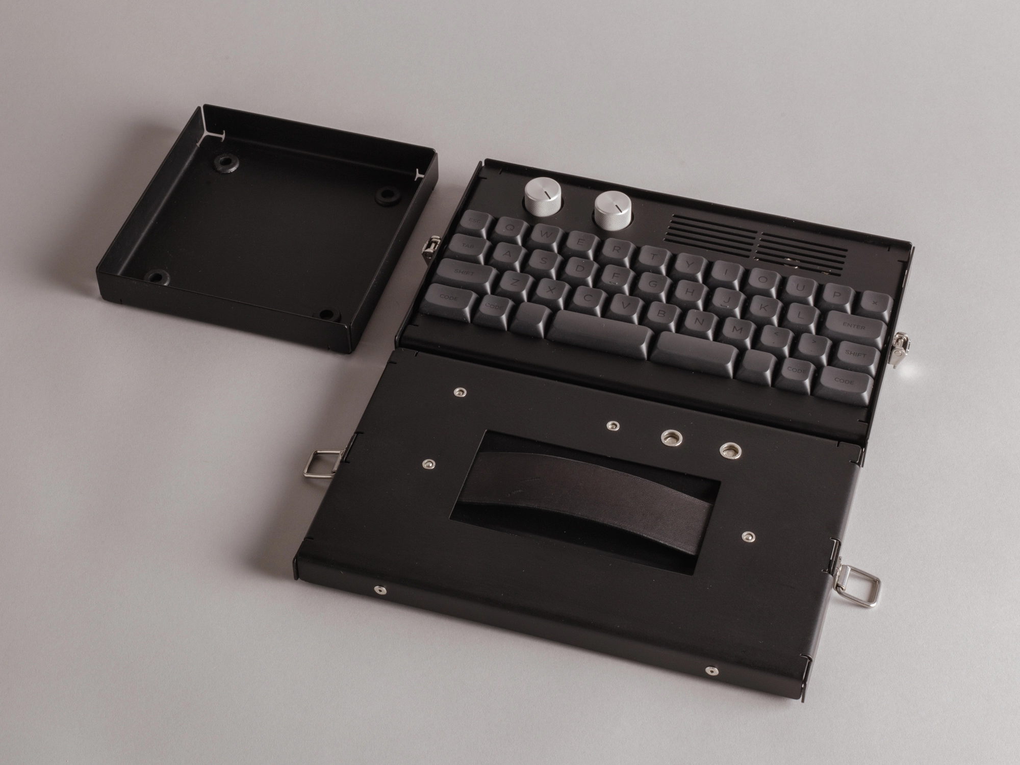 Black keyboard sitting on a grey background